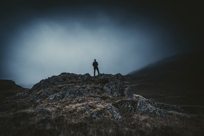 Standing on a mountain brown rocks during the day
